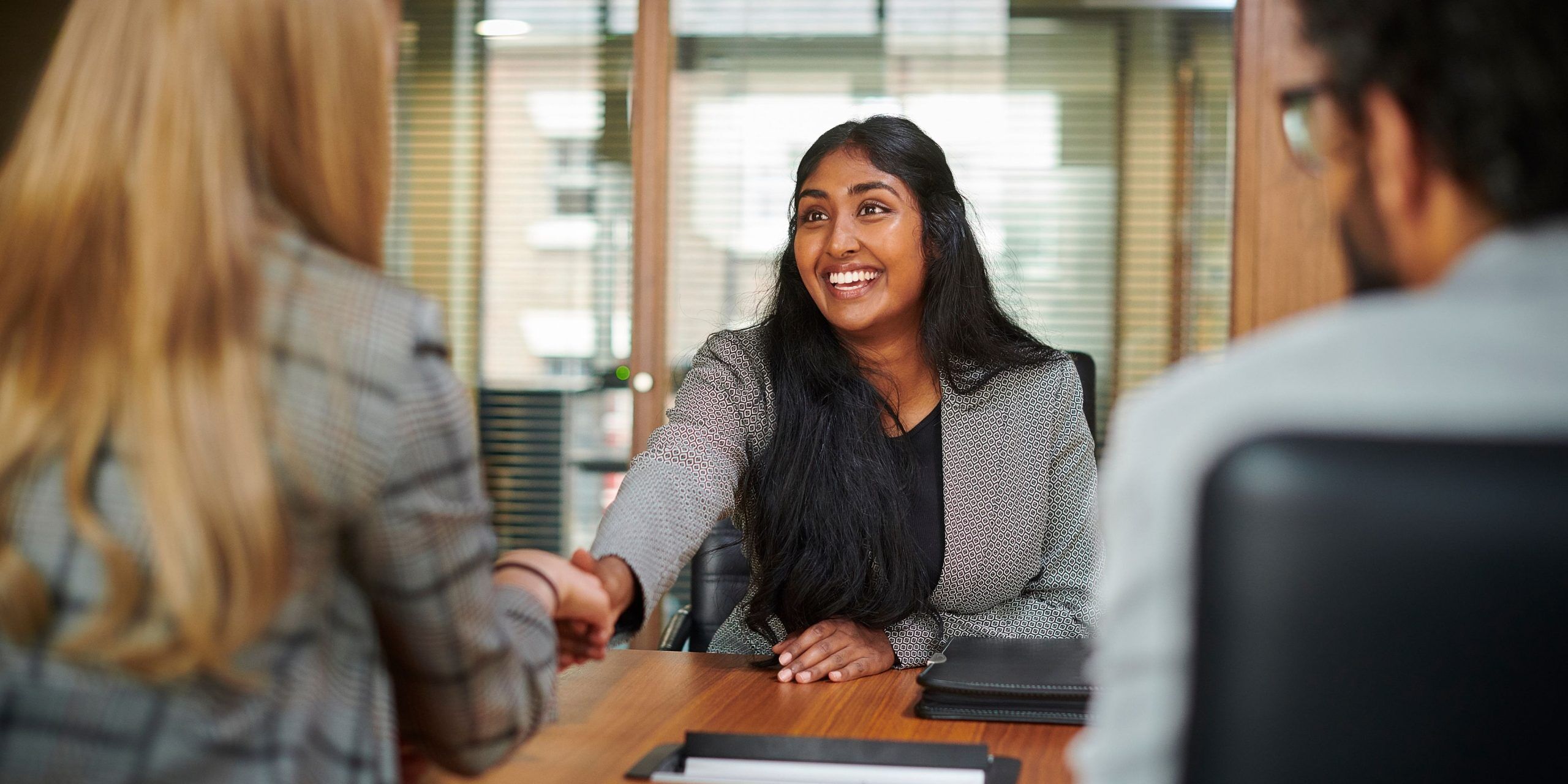An image of a candidate preparing for a job interview with a resume, notebook, and professional attire.