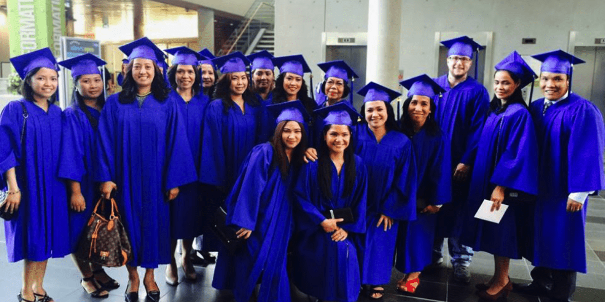 A diverse group of AOLCC graduates enjoying their graduation day, reflecting the success of targeted career training in British Columbia.